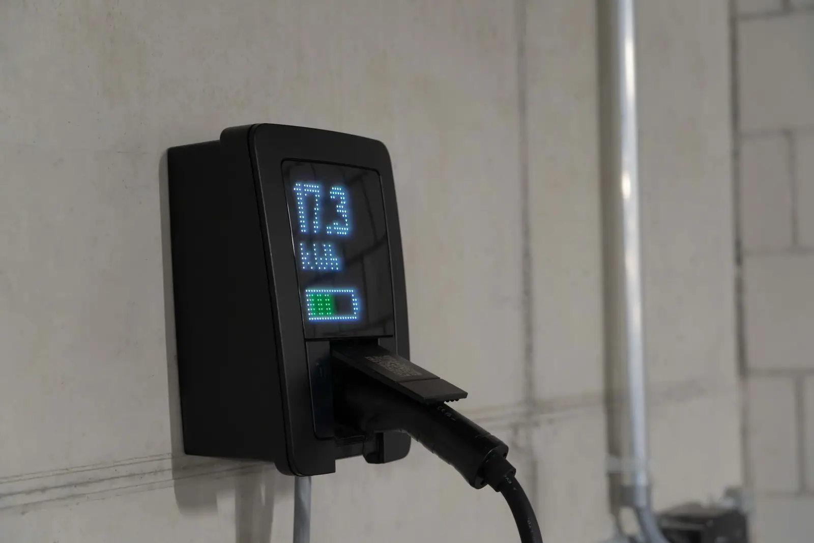 A wall-mounted charging unit showing a power reading of 17.3 kilowatts
